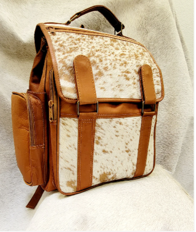 A brown and white cowhide bag