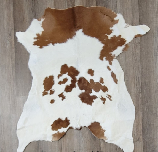 brown and white cowhide rug