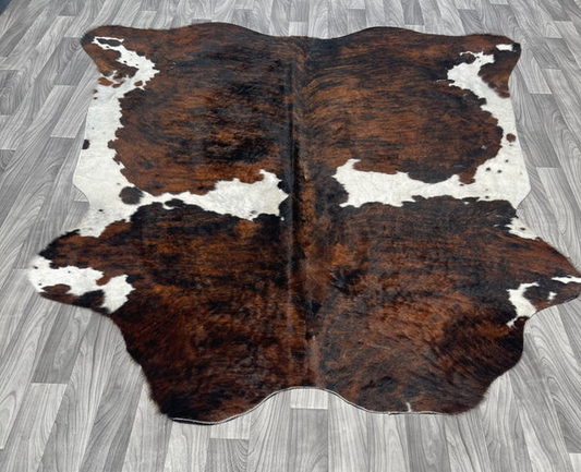 brown and white cowhide rug