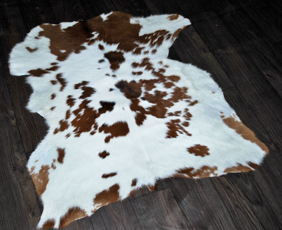 brown and white cowhide rug