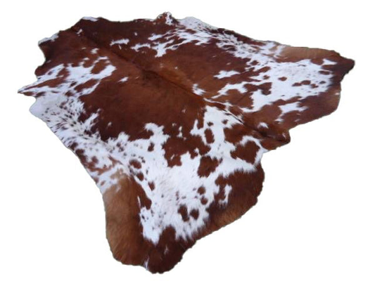 brown and white cowhide rug