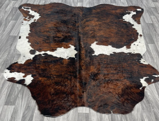 a cowhide rug on the floor