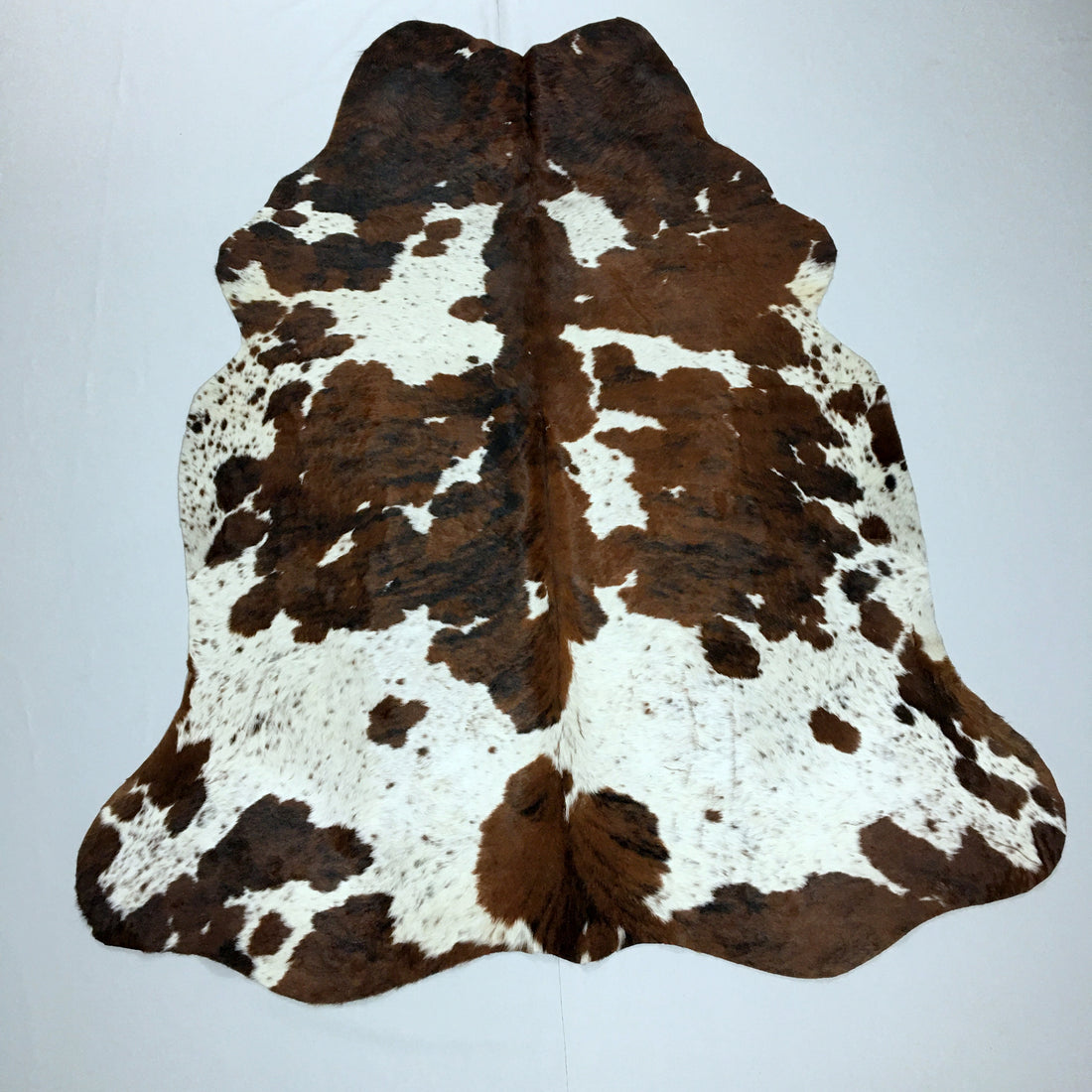 A White and Brown Cowhide Rug