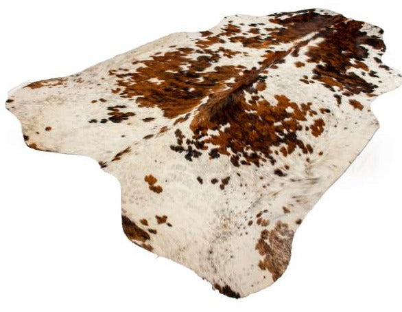 A brown and white cowhide rug