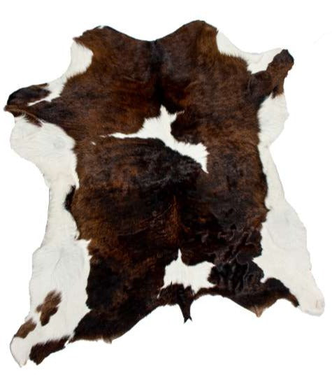 brown and white cowhide rug